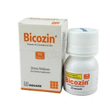 A white square box and a small white plastic bottle of Bicozin dietary supplement by Square Pharmaceuticals, featuring orange text and branding on a white background.