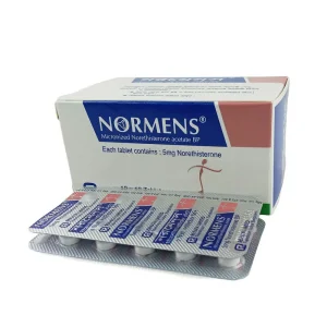 An angled view of a white, blue, and pink Normens 5 mg prescription box by Renata Limited, with two silver foil blister strips stacked directly in front of it.