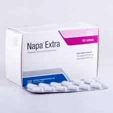 A white commercial cardboard box of Napa Extra tablets with pink and blue accents, positioned behind a single silver blister strip showing white oval-shaped pills.